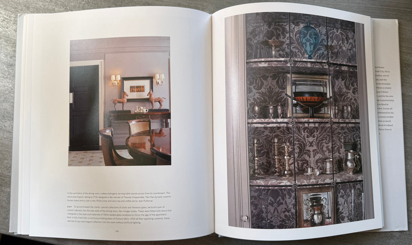 Open book with images of dining room and china cabinet with painted pattern. 
